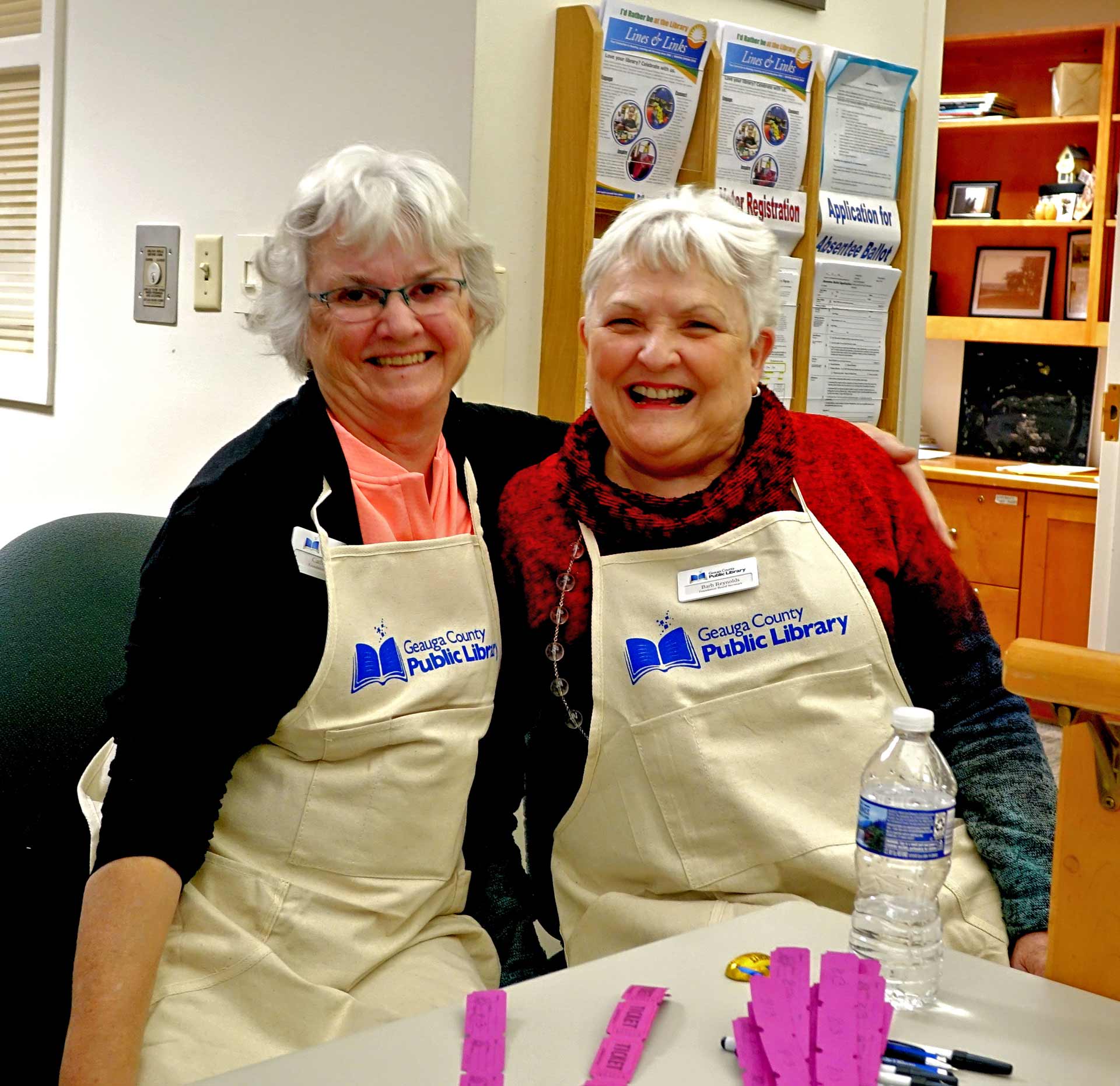 Cathy and Barb smiling in aprons
