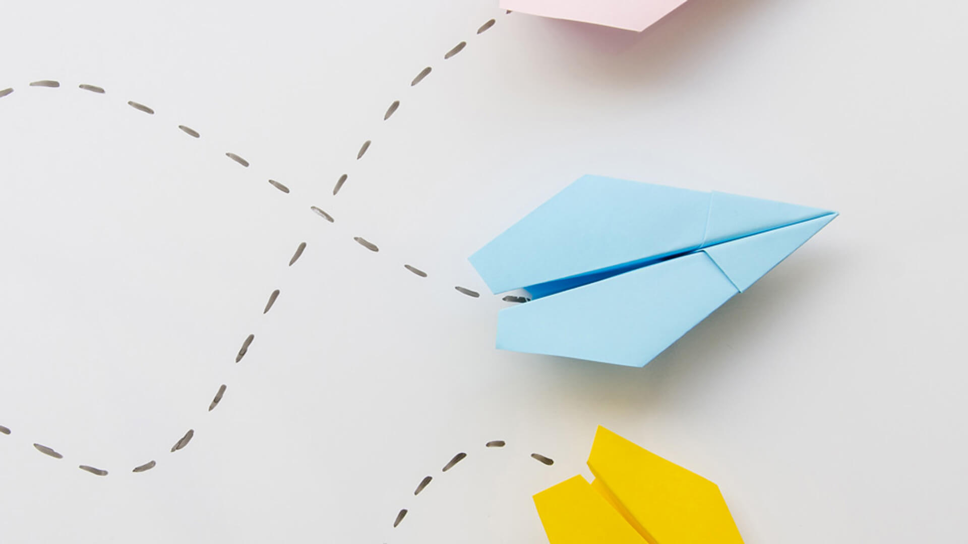 A blue paper airplane on the right side of the image is followed by a black dotted line.