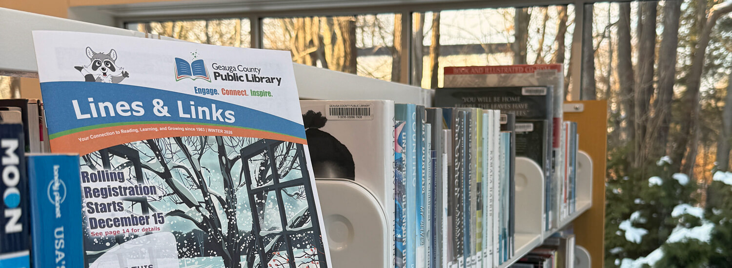 2026 Winter Lines and Links The 2026 winter edition of Geauga County Public Library’s "Lines and Links" newsletter sits on a shelf in the foreground on the left, with bookshelves visible in the background on the right.