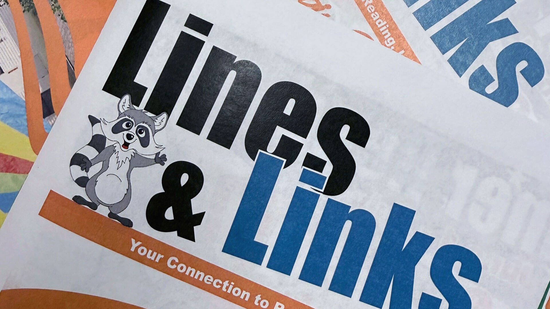 A newsletter titled "Lines & Links" with a waving cartoon raccoon.